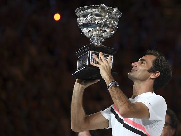 Switzerland&#039;s Roger Federer holds his trophy aloft after defeating Croatia&#039;s Marin Cilic during the men&#039;s singles final at the Australian Open tennis championships in Melbourne, Austral ...