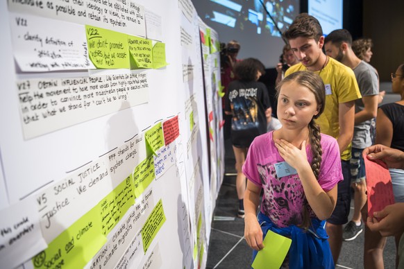 epa07757579 Swedish climate activist Greta Thunberg reacts with young activists during the &#039;Fridays For Future Summit&#039;, at the University of Lausanne (UNIL), in Lausanne, Switzerland, 05 Aug ...