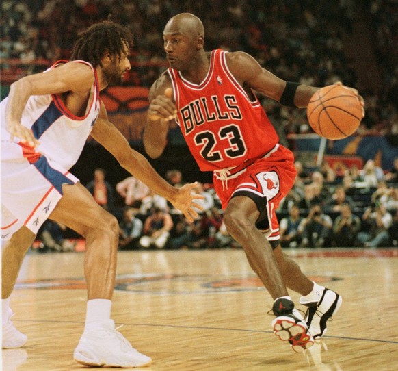 Chicago Bulls star Michael Jordan, right, dribbles PSG Racing Stephane Risacher, during the McDonald&#039;s championship semi final match between PSG Racing of France and US Chicago Bulls at the Paris ...