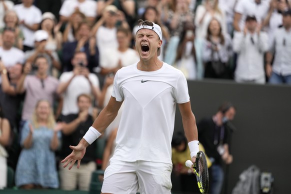 Denmark&#039;s Holger Rune celebrates after beating Spain&#039;s Alejandro Davidovich Fokina in a men&#039;s singles match on day six of the Wimbledon tennis championships in London, Saturday, July 8, ...