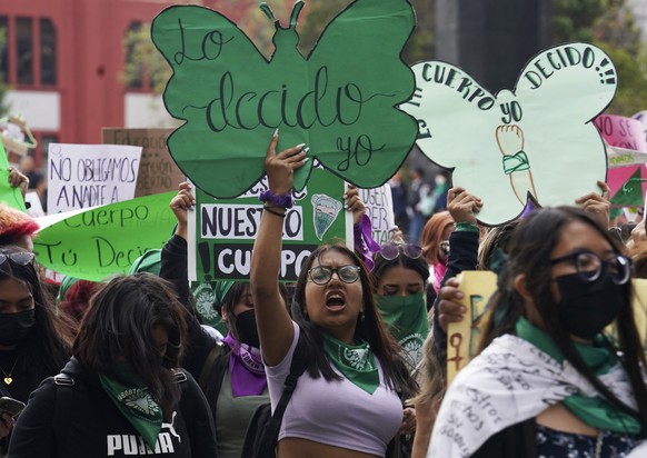 A woman holds up a sign with a message that reads in Spanish; &quot;I will decide&quot; as she joins a march demanding legal, free and safe abortions for all women, marking International Safe Abortion ...