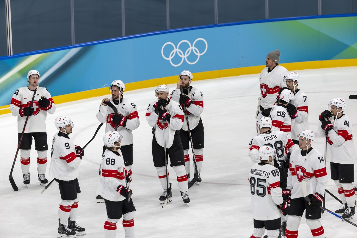 Switzerland's players look disappointed after losing against Finland during the overtime of men's ice hockey quarterfinal game between Finland and Switzerland at the 2026 Olympic Winter Game ...