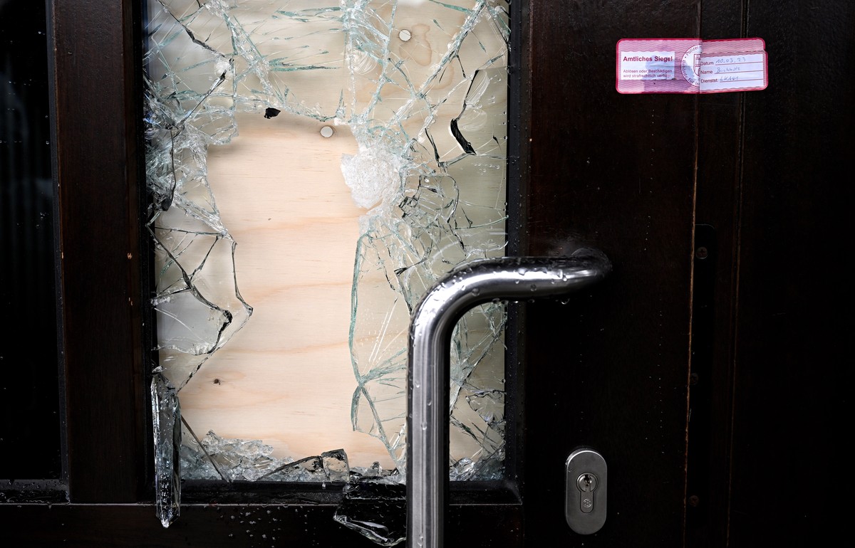 epa10513578 A police seal on the damaged door to the building that houses the Kingdom Hall of Jehovah's Witnesses, the day after a deadly shooting in Hamburg, Germany, 10 March 2023. According to ...