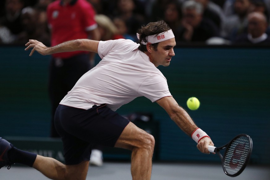 Roger Federer of Switzerland returns the ball to Novak Djokovic of Serbia during their semifinal match of the Paris Masters tennis tournament at the Bercy Arena in Paris, France, Saturday, Nov. 3, 201 ...