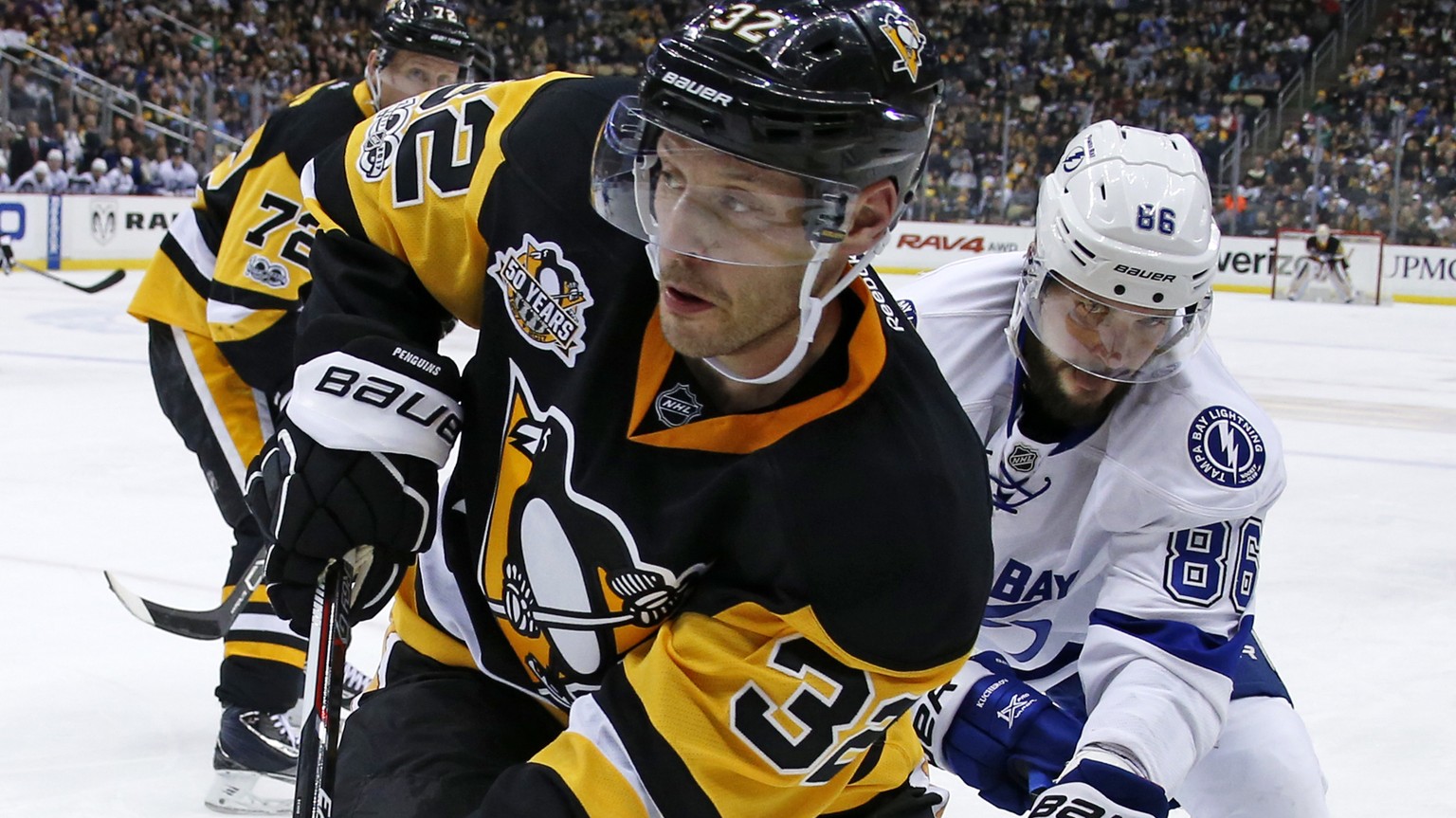 Pittsburgh Penguins&#039; Mark Streit (32) works the puck in the corner in front of Tampa Bay Lightning&#039;s Nikita Kucherov (86) during the second period of an NHL hockey game in Pittsburgh, Friday ...