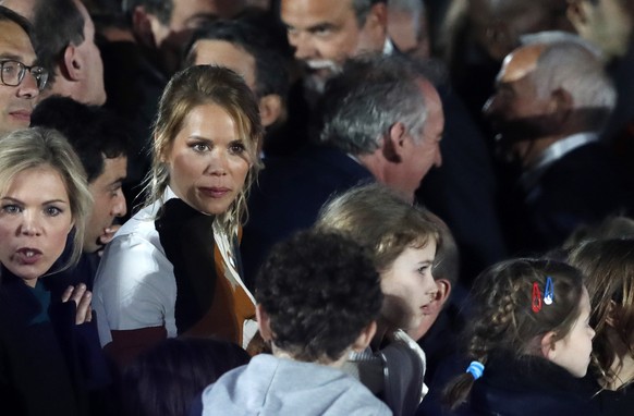 epa09907374 Daughter of French first lady Brigitte Macron, Tiphaine Auziere (C) arrives at the Champs-de-Mars after French President Emmanuel Macron won the second round of the French presidential ele ...