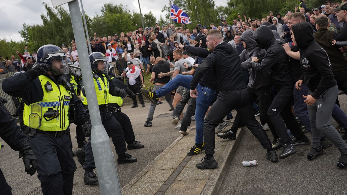 Trouble flares during an anti-immigration protest outside the Holiday Inn Express in Rotherham, England, Sunday Aug. 4, 2024. (Danny Lawson/PA via AP)