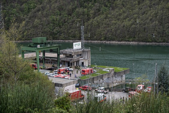 epa11268266 A general view shows rescuers working at the scene of an explosion that occurred in a hydroelectric power plant on the Lake Suviana reservoir, near Bologna, northern Italy, 09 April 2024.  ...
