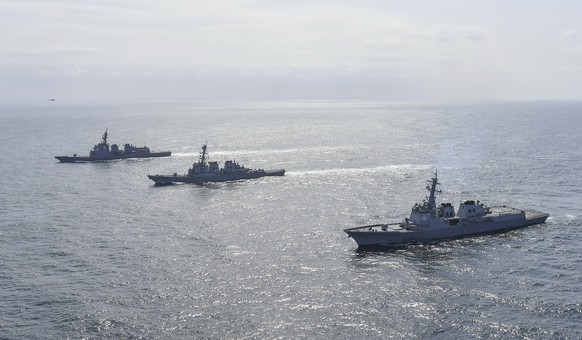 epa10576494 A handout photo made available by the South Korean Defense Ministry shows, Benfold (R) of the US Navy, Aegis-equipped destroyers Yulgok Yi I (C) of the South Korean Navy and the JS Atago ( ...