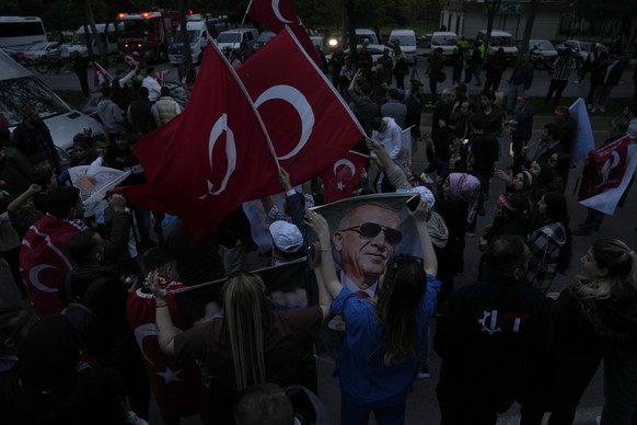 Supporters of President Recep Tayyip Erdogan cheer outside the headquarters of AK Party in Istanbul, Turkey, Sunday, May 14, 2023. More than 64 million people, including 3.4 million overseas voters, w ...