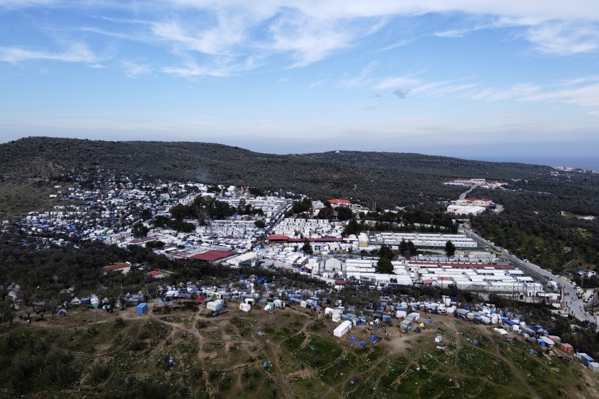 The overcrowded Moria refugee camp is seen from above on the northeastern Aegean island of Lesbos, Greece, Monday, Feb. 24, 2020. Protest groups on three eastern Greek islands have begun setting up bl ...