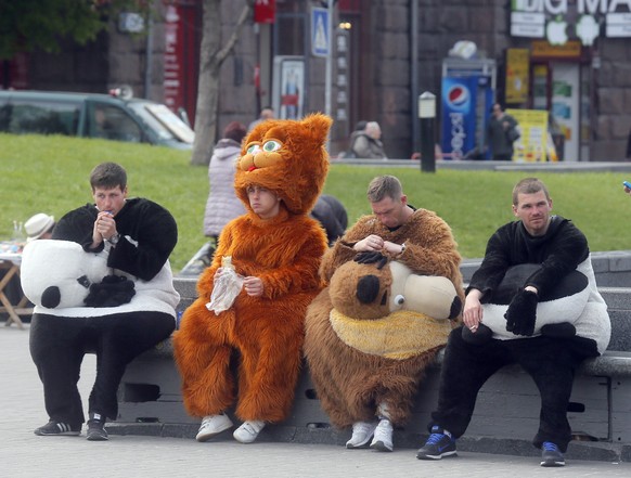 People dressed as cartoon characters to promote the Eurovision Song Contest, take a break in Kiev, Ukraine, Friday, April 28, 2017. Kiev will host the Eurovision Song Contest with the final taking pla ...