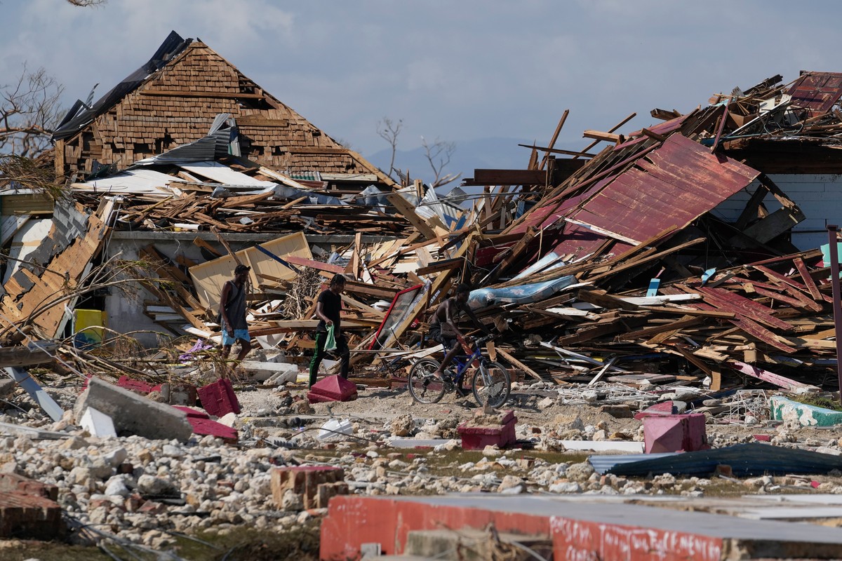 Residents make their way past piles of debris in the aftermath of Hurricane Melissa in Black River, Jamaica, Thursday, Oct. 30, 2025. (AP Photo/Matias Delacroix)
Jamaica Extreme Weather