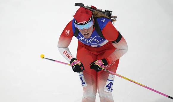 Lena Haecki of Switzerland crosses the finish line during the women&#039;s 15-kilometer individual race at the 2022 Winter Olympics, Monday, Feb. 7, 2022, in Zhangjiakou, China. (AP Photo/Kirsty Wiggl ...