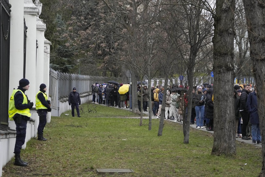 Russians queue at the Russian Embassy in Warsaw, Poland, Sunday, March 17, 2024 to cast their vote on the last day of the three-day presidential elections. Russians at home and abroad are heading to t ...