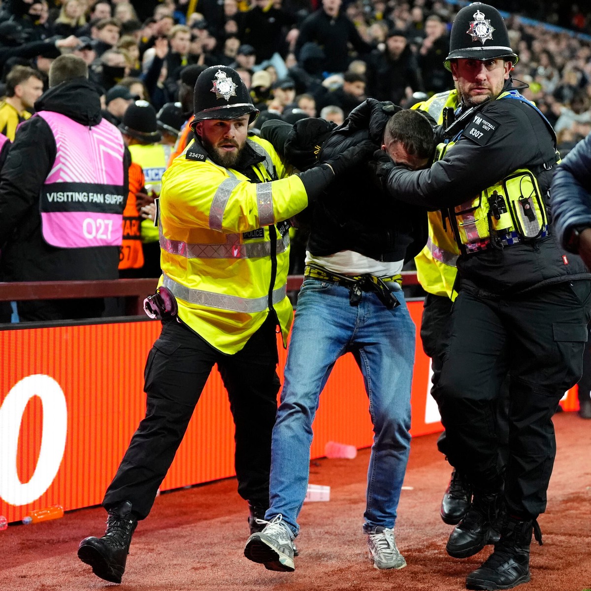 A Young Boys fan is escorted from the stadium by police during the Europa League soccer match between Aston Villa and Young Boys in Birmingham, England, Thursday, Nov. 27, 2025. (Nick Potts/PA via AP) ...