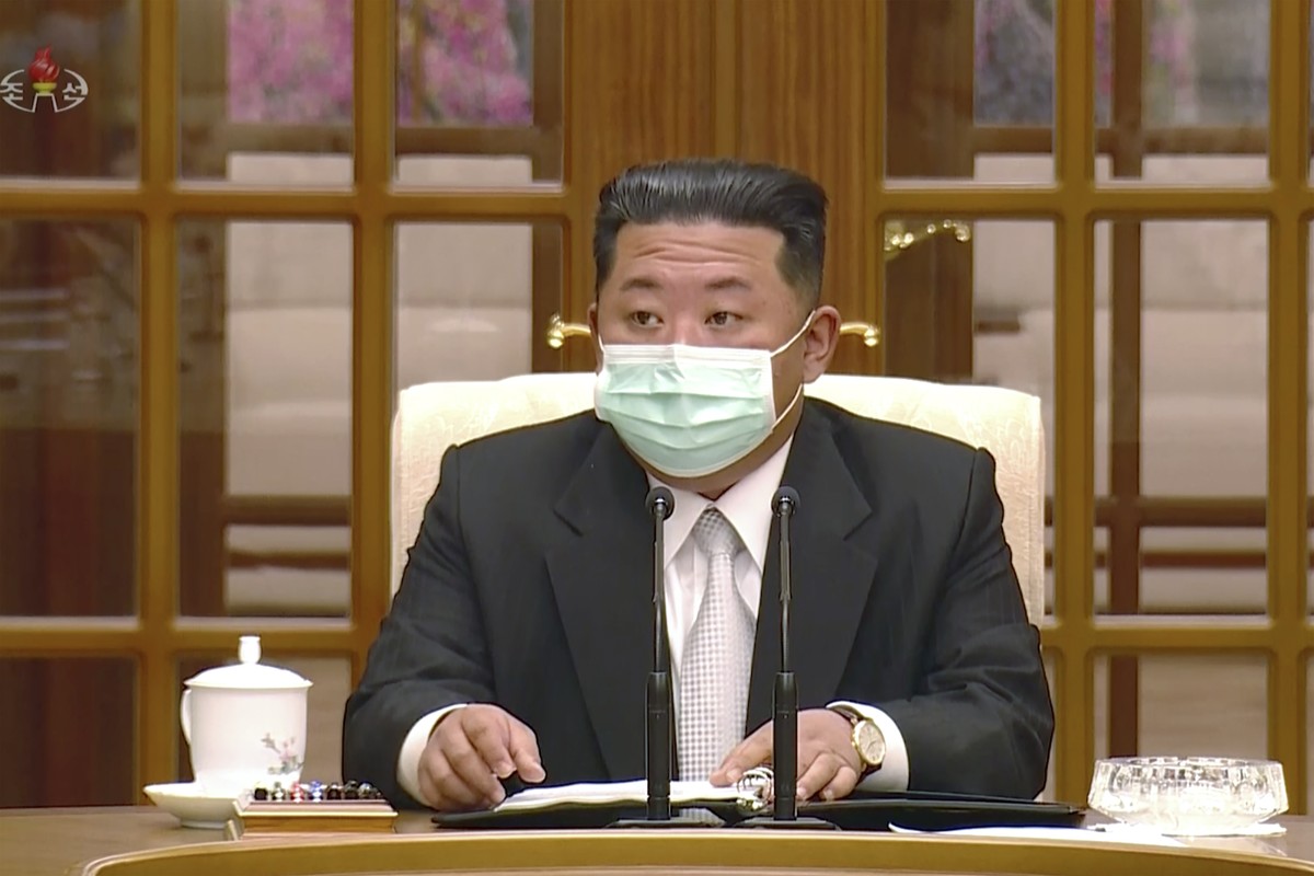 In this image made from video broadcasted by North Korea's KRT, North Korean leader Kim Jong Un wears a face mask on state television during a meeting acknowledging the country's first case  ...