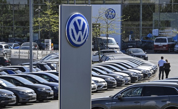 In this April 20, 2020 file photo, a Volkswagen car dealer is open in Essen, Germany. In times when a pandemic unleashes death and poverty, the concept of what is essential to keep society functioning in a lockdown is gripping Europe. What may stay open in one country may be designated as non-essential just across the border. (AP Photo/Martin Meissner, File)