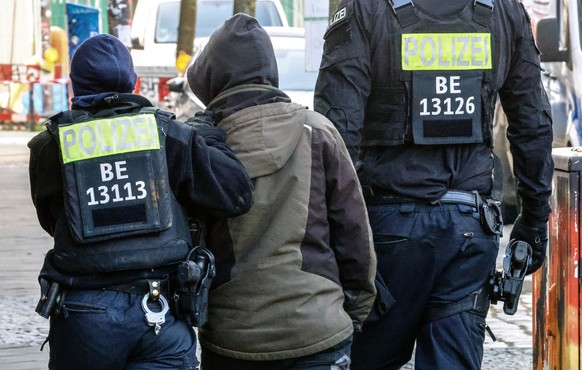 epa11196011 Members of a special police unit escort a person during a search operation for long-sought former members of Germany&#039;s Red Army Faction (RAF) militant group, Ernst Volker Staub and Bu ...