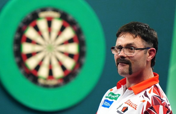 Australia's Damon Heta celebrates victory against Switzerland's Stefan Bellmont in the Round 2 match on day eleven of the World Darts Championship at the Alexandra Palace, in London, Sunday, ...