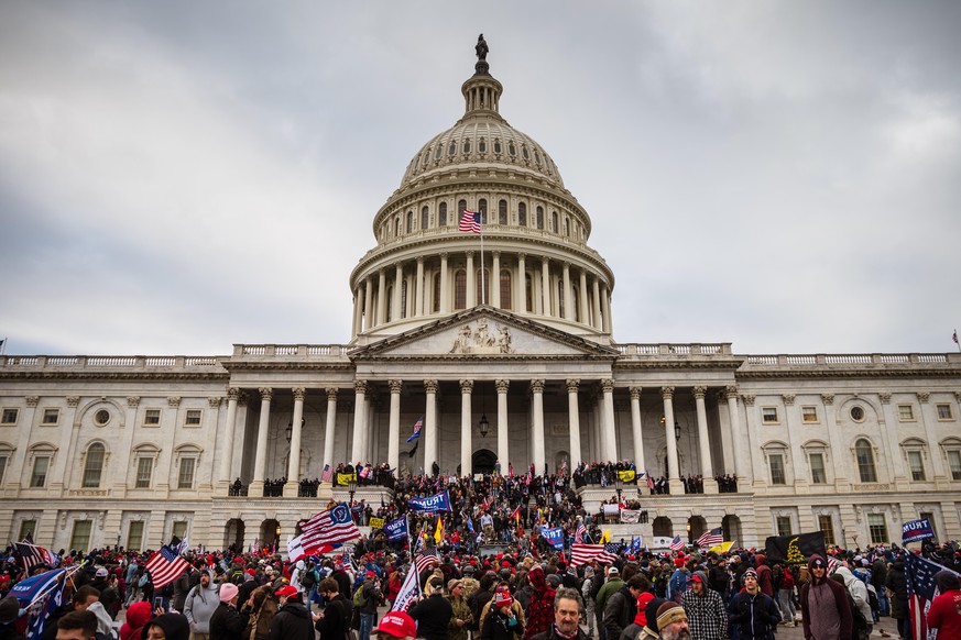 WASHINGTON, DC - JANUARY 06: A large group of pro-Trump protesters stand on the East steps of the Capitol Building after storming its grounds on January 6, 2021 in Washington, DC. A pro-Trump mob stor ...