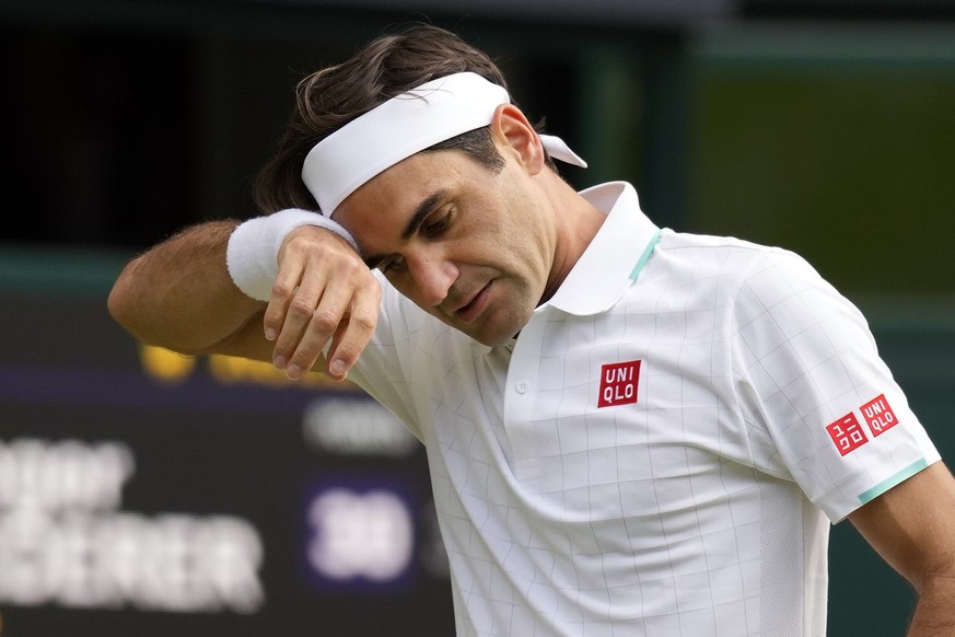 FILE - In this July 7, 2021, file photo, Switzerland&#039;s Roger Federer wipes his brow during the men&#039;s singles quarterfinals match against Poland&#039;s Hubert Hurkacz on day nine of the Wimbl ...