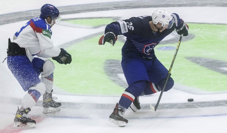 epa09945280 Bault Romain (R) from France and Kristof Michal from Slovakia in actio during the preliminary round group A match between France and Slovakia at the IIHF Ice Hockey World Championship 2022 ...