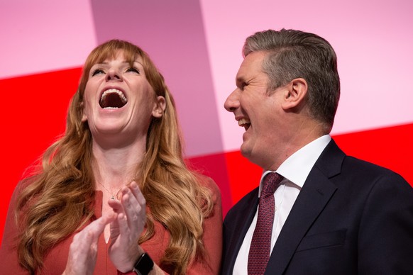 epa10211326 Leader of the Labour Party Sir Keir Starmer (R) and Deputy Leader of the Labour Party Angela Rayner (C) share a joke following Angela Rayner?s closing speech at the Labour Party Conference ...