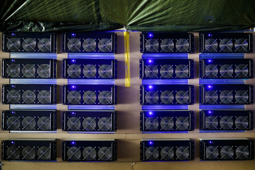 Racks of computers hosting six graphic cards each are pictured in a cryptocurrency mine in the small alpine village of Gondo, Switzerland, Monday, May 7, 2018. The village formerly host to gold mining ...