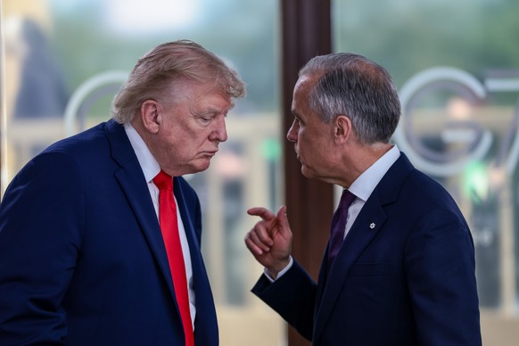 President Donald Trump speaks with Canadian Prime Minister Mark Carney, right, at a working lunch with leaders of G7 and the Middle East in Evian-les-Bains, France, Tuesday, June 16, 2026. (Evelyn Hoc ...