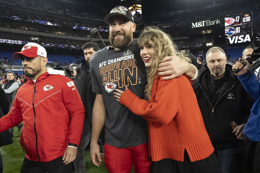 FILE - Kansas City Chiefs tight end Travis Kelce walks with Taylor Swift following the AFC Championship NFL football game between the Baltimore Ravens and the Kansas City Chiefs, Sunday, Jan. 28, 2024 ...