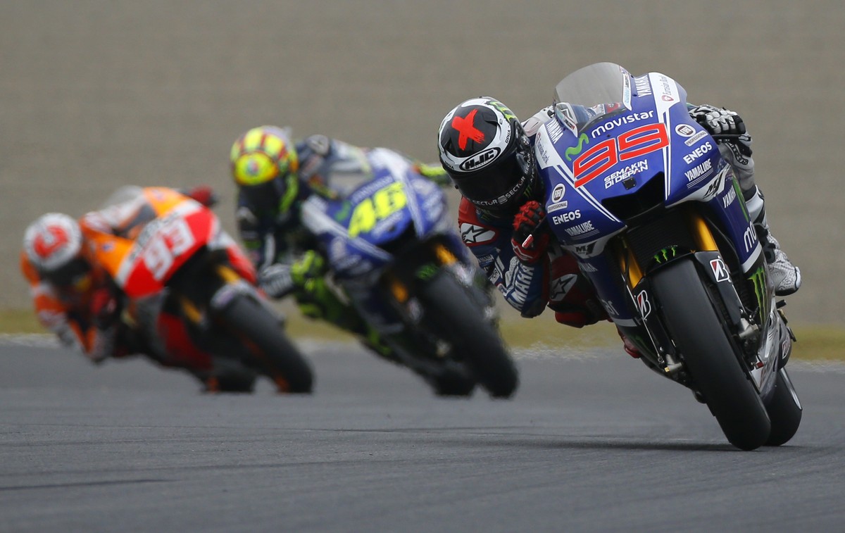 Jorge Lorenzo of Spain steers his Yamaha tailed by Italy's Valentino Rossi on Yamaha and Spain's Marc Marquez on Honda during the Japanese Grand Prix at Twin Ring Motegi circuit in Motegi, n ...