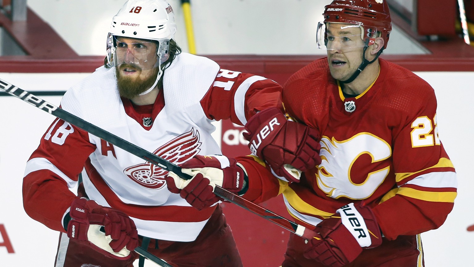 Detroit Red Wings defenceman Marc Staal (18) battles Calgary Flames centre Trevor Lewis (22) during the first period of period of an NHL hockey game Saturday, March 12, 2022 in Calgary, Alberta. (Larr ...