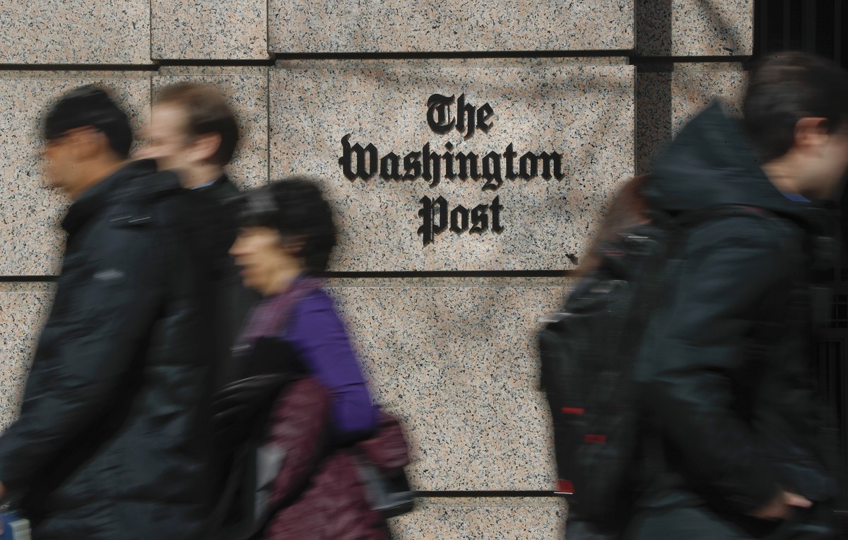 FILE - People walk by the One Franklin Square Building, home of The Washington Post newspaper, in downtown Washington, Feb. 21, 2019. The struggling Washington Post was in some turmoil on Monday, June ...