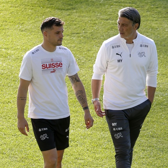 Switzerland&#039;s head coach Murat Yakin, right, talks to his captain Granit Xhaka, during a training session of the substitute players at the &quot;Stadion auf der Waldau&quot; in Stuttgart, Germany ...