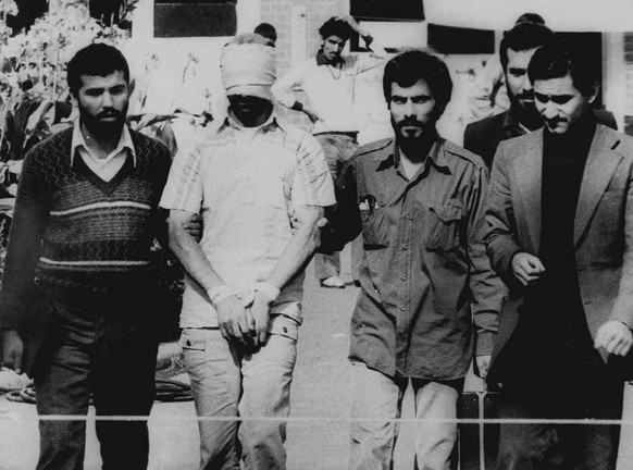 FILE - In this Nov. 9, 1979 file photo, one of the hostages seized when Islamic radicals stormed the U.S. Embassy in Tehran, blindfolded and with his hands bound, is displayed to a crowd in Tehran, Ir ...