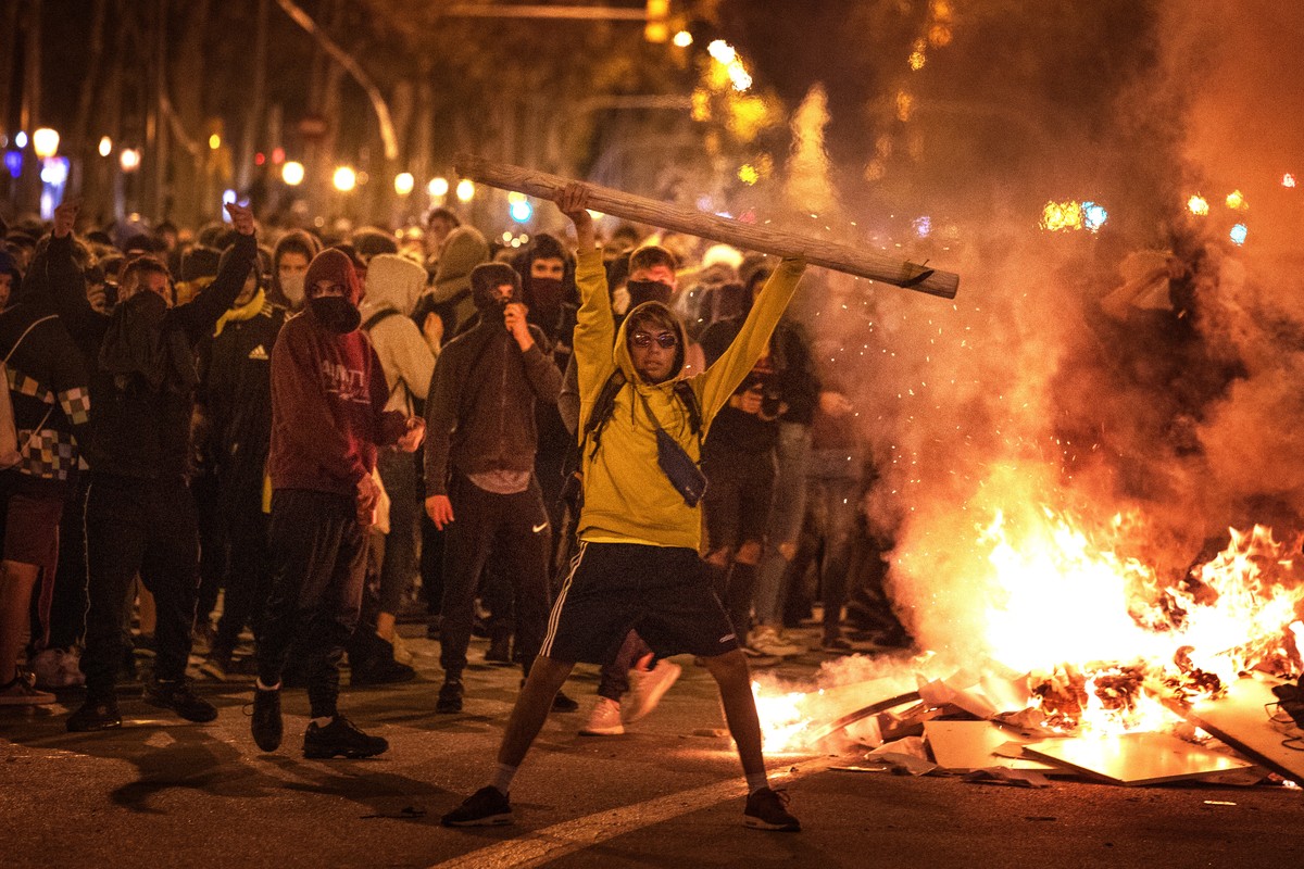 Protestors make barricades in the street during clashes with police in Barcelona, Spain, Wednesday, Oct. 16, 2019. Spain's government said Wednesday it would do whatever it takes to stamp out vio ...