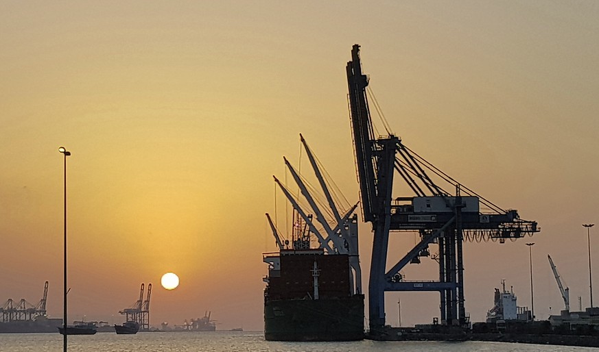 In this photo taken Tuesday, March 13, 2018 the sun sets in the port of Djibouti. The tiny Horn of Africa nation of Djibouti with less than 1 million inhabitants, has become a military outpost for Chi ...