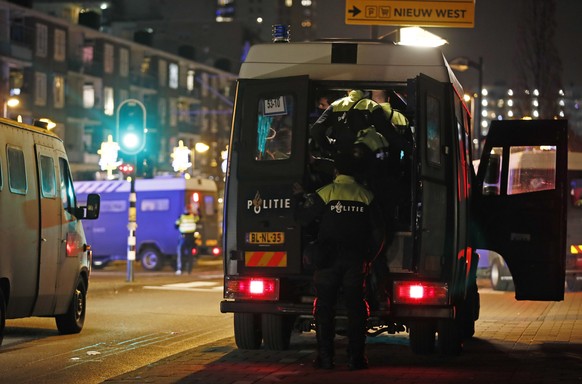 Police officers block a road during a nation-wide curfew in Amsterdam, Netherlands, Tuesday, Jan. 26, 2021. The Netherlands entered its toughest phase of anti-coronavirus restrictions to date, imposin ...