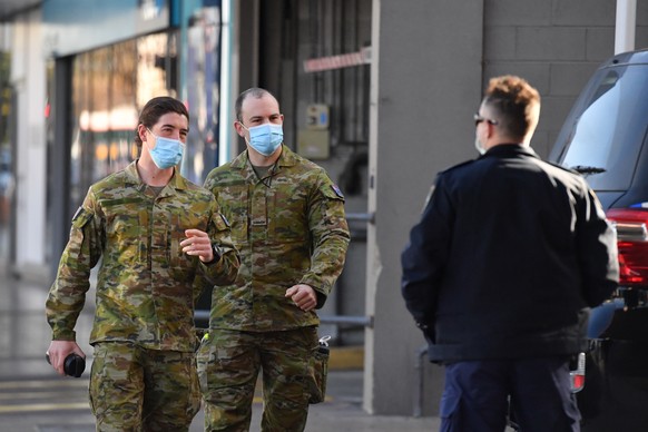 epa09388251 Australian Defence Force personnel and NSW police are seen at Fairfield in the south west suburb of Sydney, Australia, 02 August 2021. Some 300 ADF troops will reinforce the efforts of pol ...