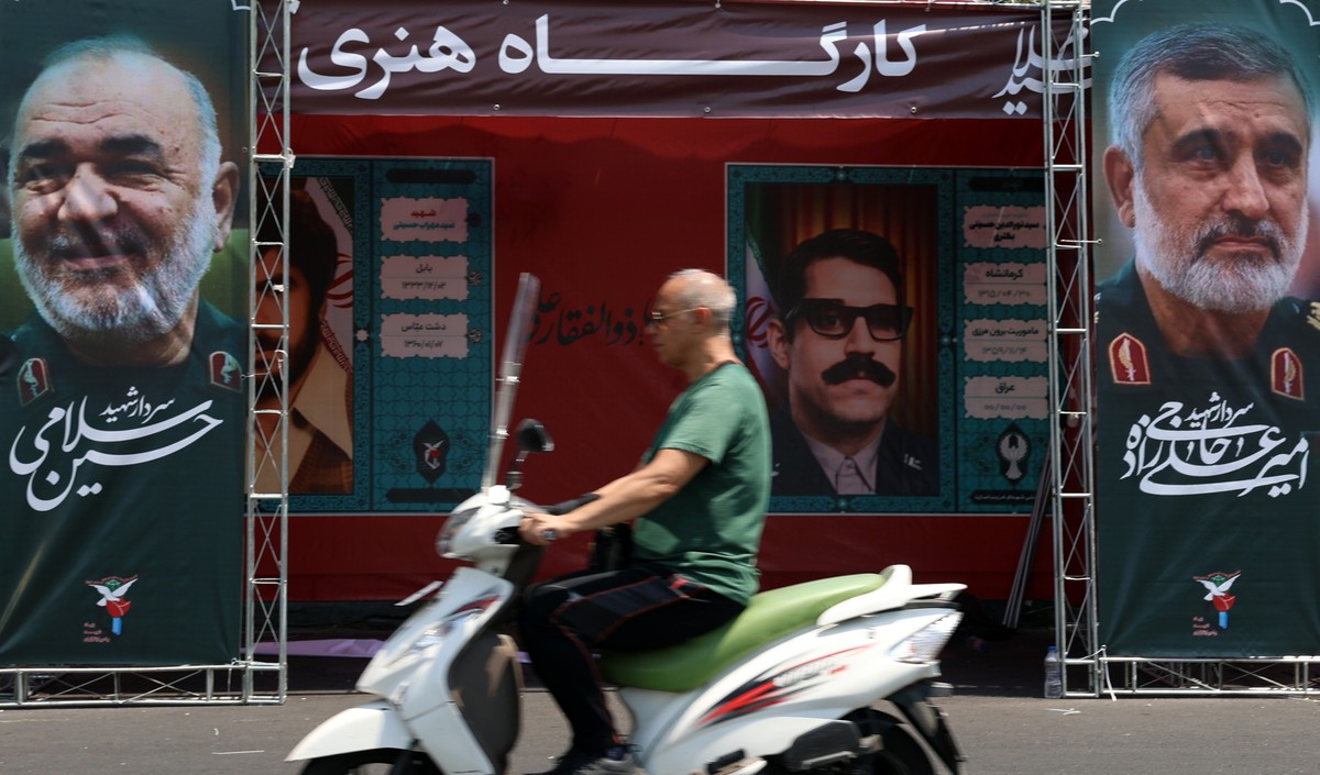 epa12174713 Iranians drive past banners with the portraits of late commander-in-chief of the Islamic Revolutionary Guard Corps (IRGC) Hossein Salami (L) and late commander of the IRGC Aerospace Forces ...