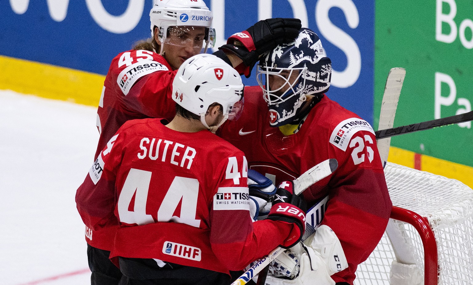 epa09953725 (L-R) - Switzerland&#039;s Michael Fora, Pius Suter and goaltender Sandro Aeschlimann celebrate their victory after the Ice Hockey World Championship group A preliminary round match betwee ...