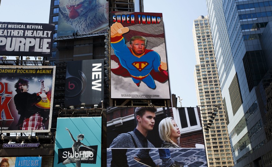 epa05539981 A view of a new electronic billboard supporting US Republican presidential candidate Donald Trump, which depicts him as &quot;Super Trump&quot;, in Times Square in New York, New York, USA, ...