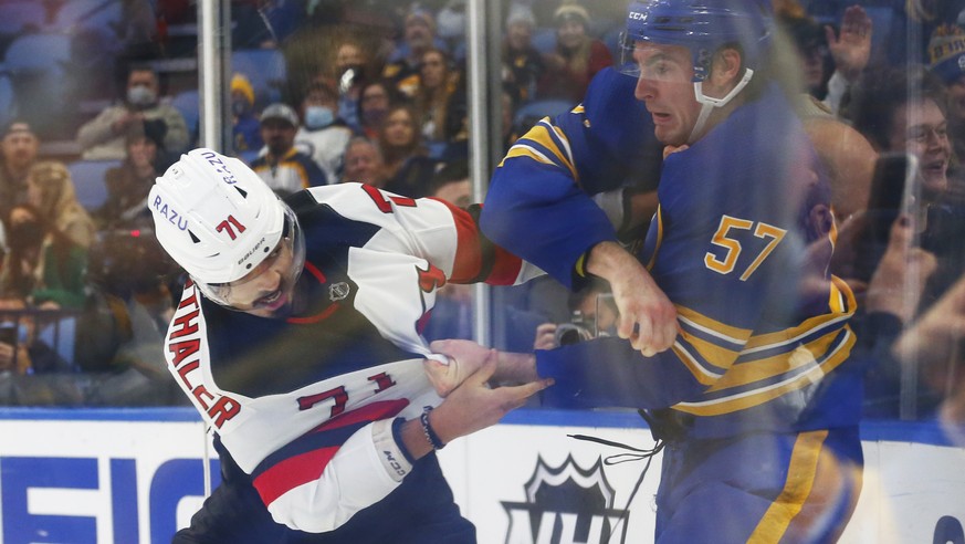 New Jersey Devils defenseman Jonas Siegenthaler (71) and Buffalo Sabres left wing Brett Murray (57) fight during the first period of an NHL hockey game, Wednesday, Dec. 29, 2021, in Buffalo, N.Y. (AP  ...