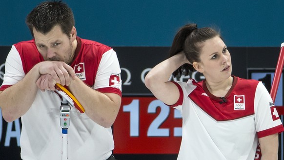 Martin Rios of Switzerland, Jenny Perret of Switzerland, and Aleksandr Krushelnitckii of the Olympic Athlete from Russia, from left, during the Mixed Doubles Curling semi final game between Switzerlan ...