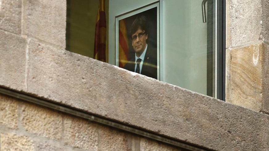 A portrait of ousted regional leader Carles Puigdemont is seen inside the Palau Generalitat in Barcelona, Spain, Monday Oct. 30, 2017. Catalonia&#039;s civil servants face their first full work week s ...