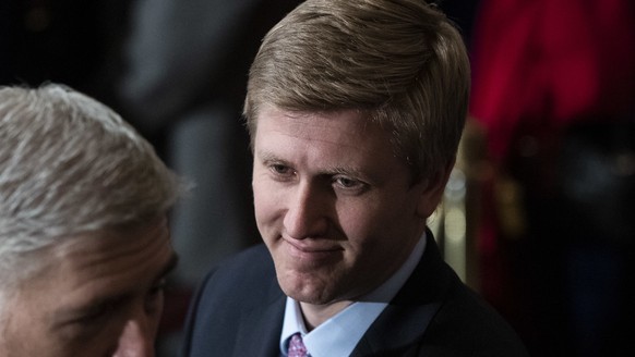 Nick Ayers listens as Supreme Court Associate Justice Neil Gorsuch waits for the arrival of the casket for former President George H.W. Bush to lie in State at the Capitol on Capitol Hill in Washingto ...