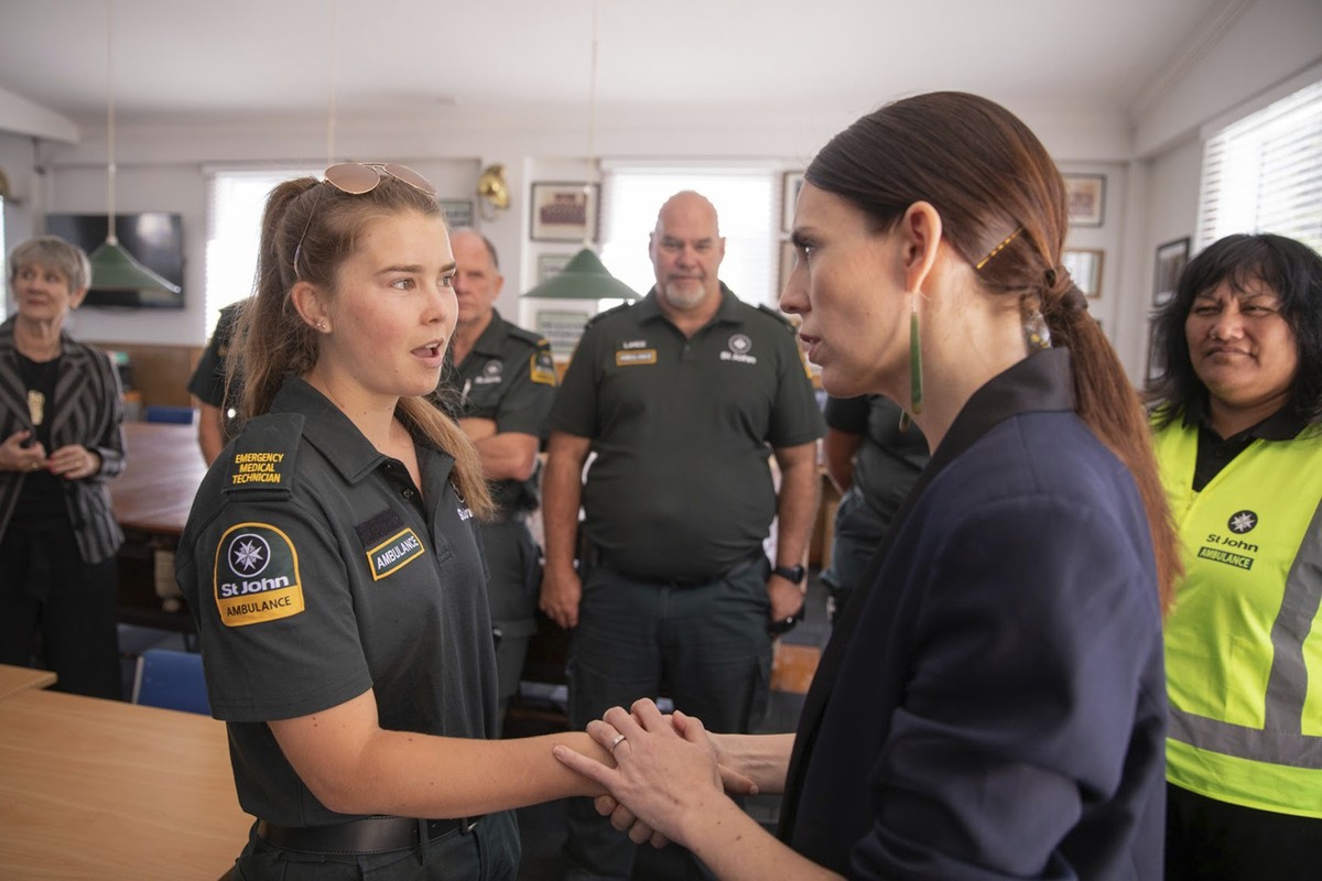 New Zealand's Prime Minister Jacinda Ardern, right, talks with first responders in Whakatane, New Zealand, Tuesday, Dec. 10, 2019. A volcanic island in New Zealand erupted Monday Dec. 9 in a towe ...