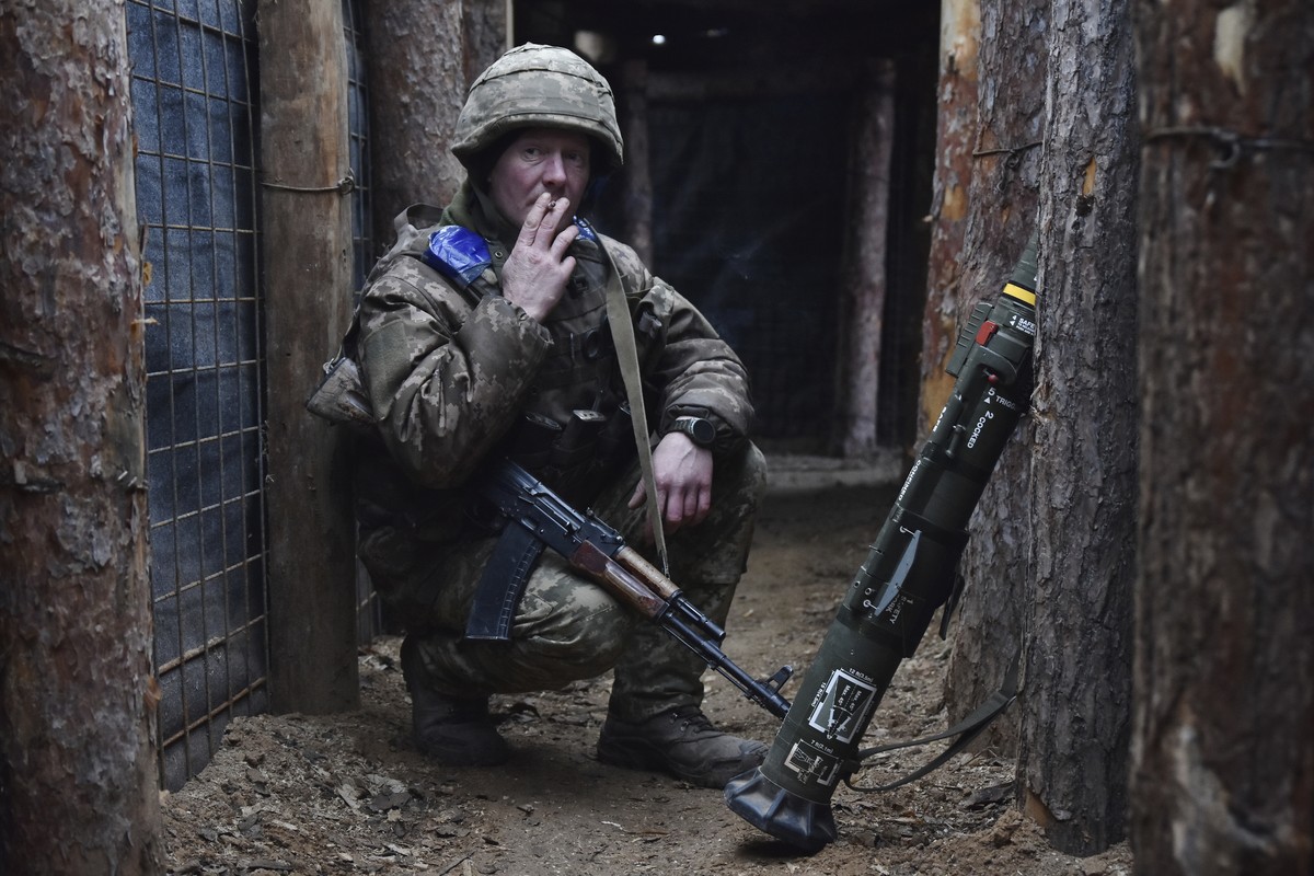 In this photo provided by Ukraine's 65th Mechanised Brigade press service, a Ukrainian soldier smokes in a trench on the frontline in Zaporizhzhia region, Ukraine, Tuesday, Dec. 31, 2024, (Andriy ...