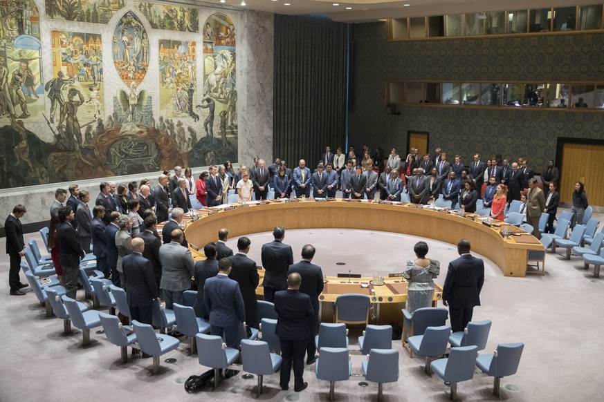 The United Nations Security Council observes a moment of silence in honor of former Secretary-General Kofi Annan before a meeting on threats to international peace and security caused by terrorist act ...